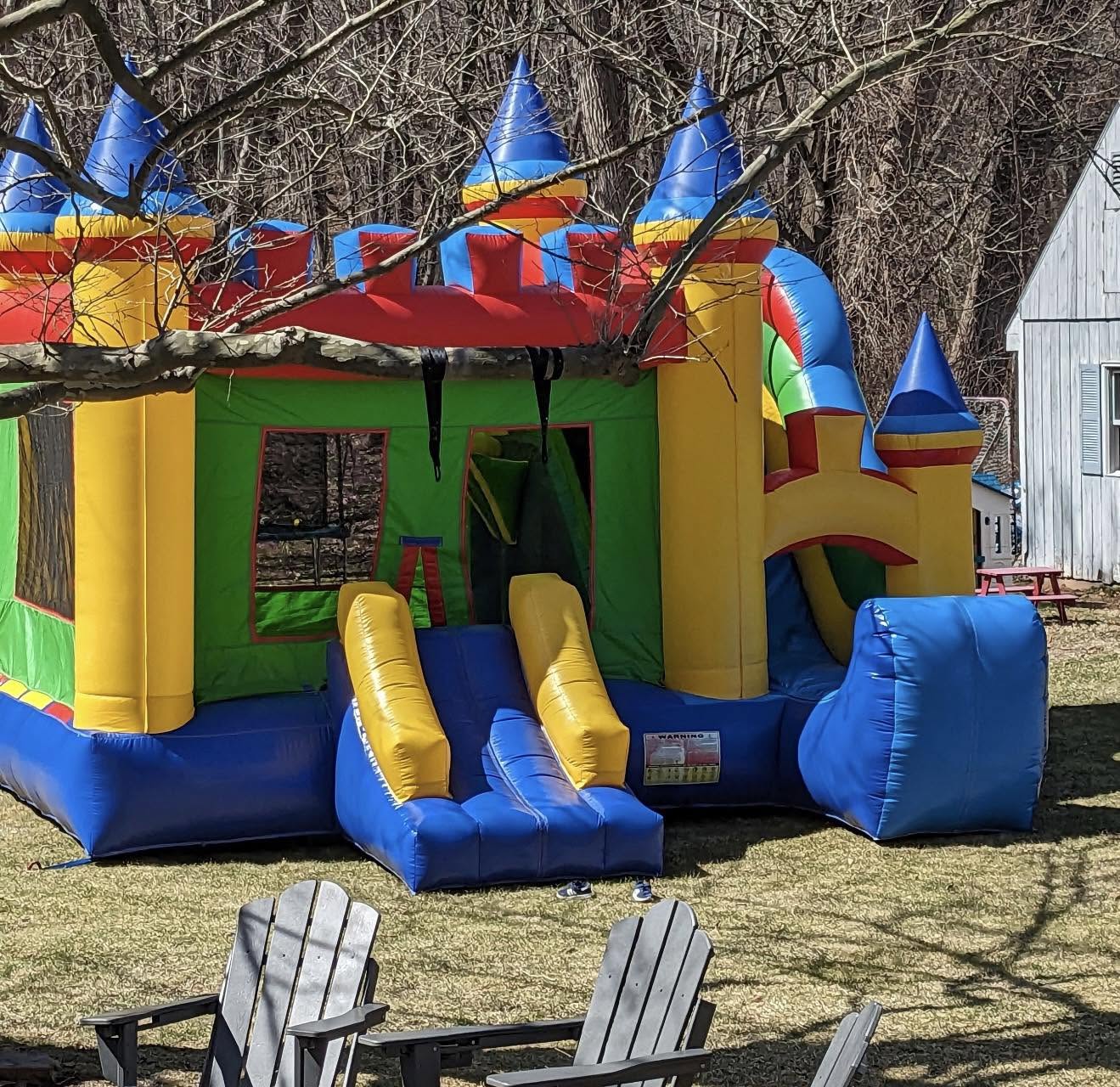 Colorful bounce house combo with slide