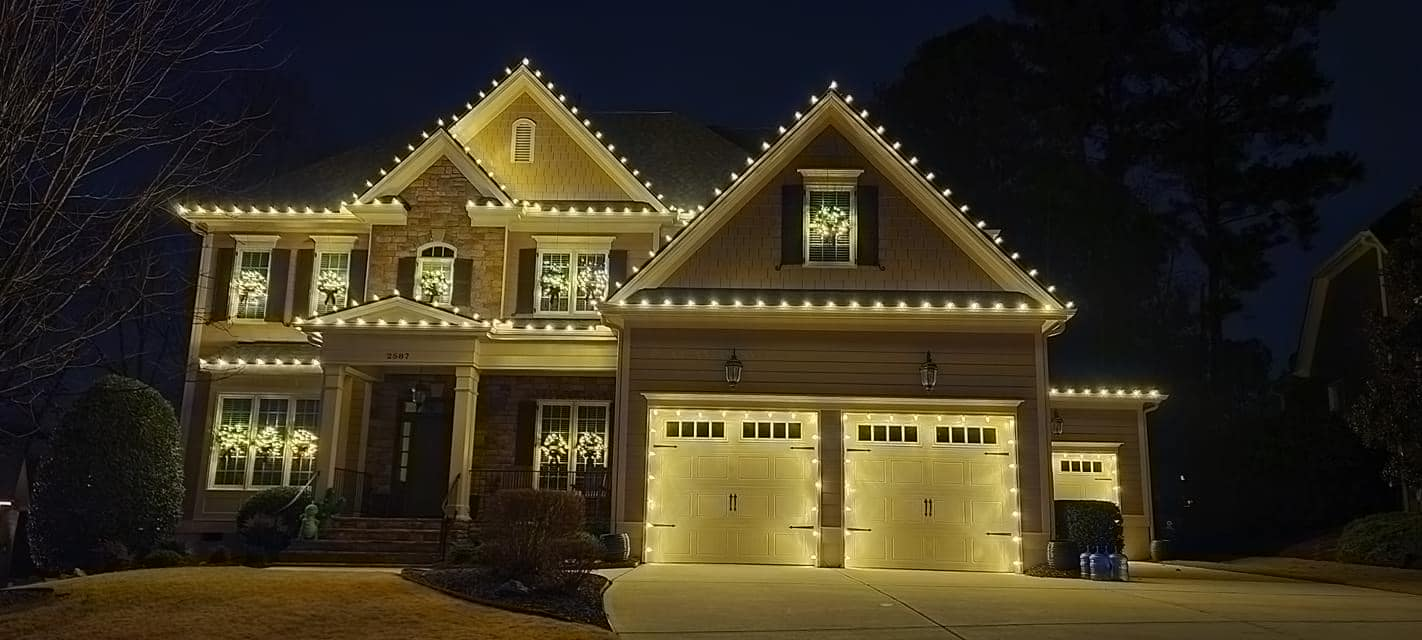 Houston home wrapped in warm white Christmas lights at night